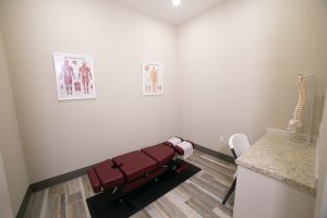 Medical office exam room with examination table and posters