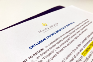 White paper with blue text that reads "Exclusive Listing Contract For Sale"
