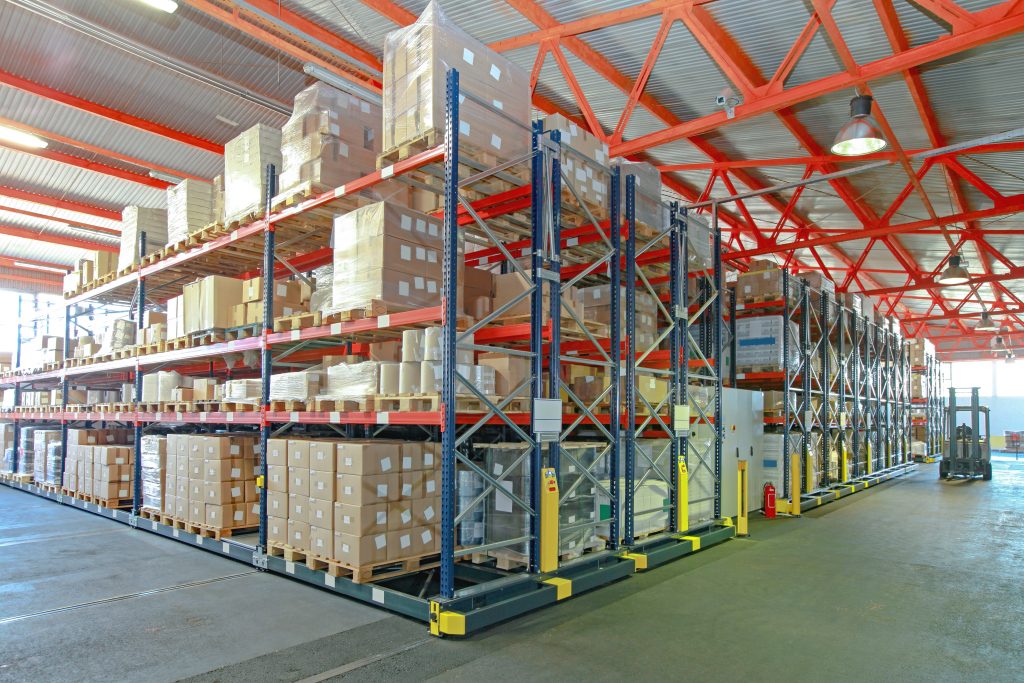 Boxes stacked on shelves in large industrial property