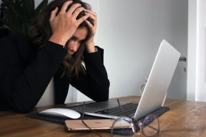 Woman with hands on her head looking stressed