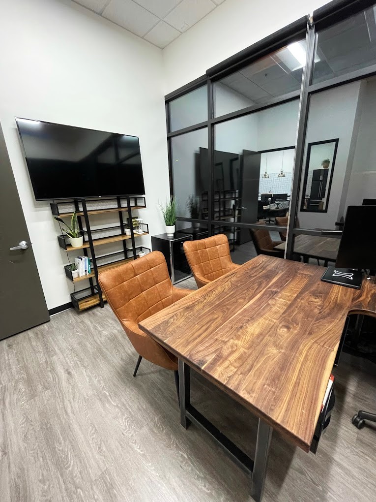 Two brown office chairs at wood desk