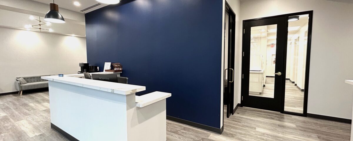 Dental office front desk in front of blue wall