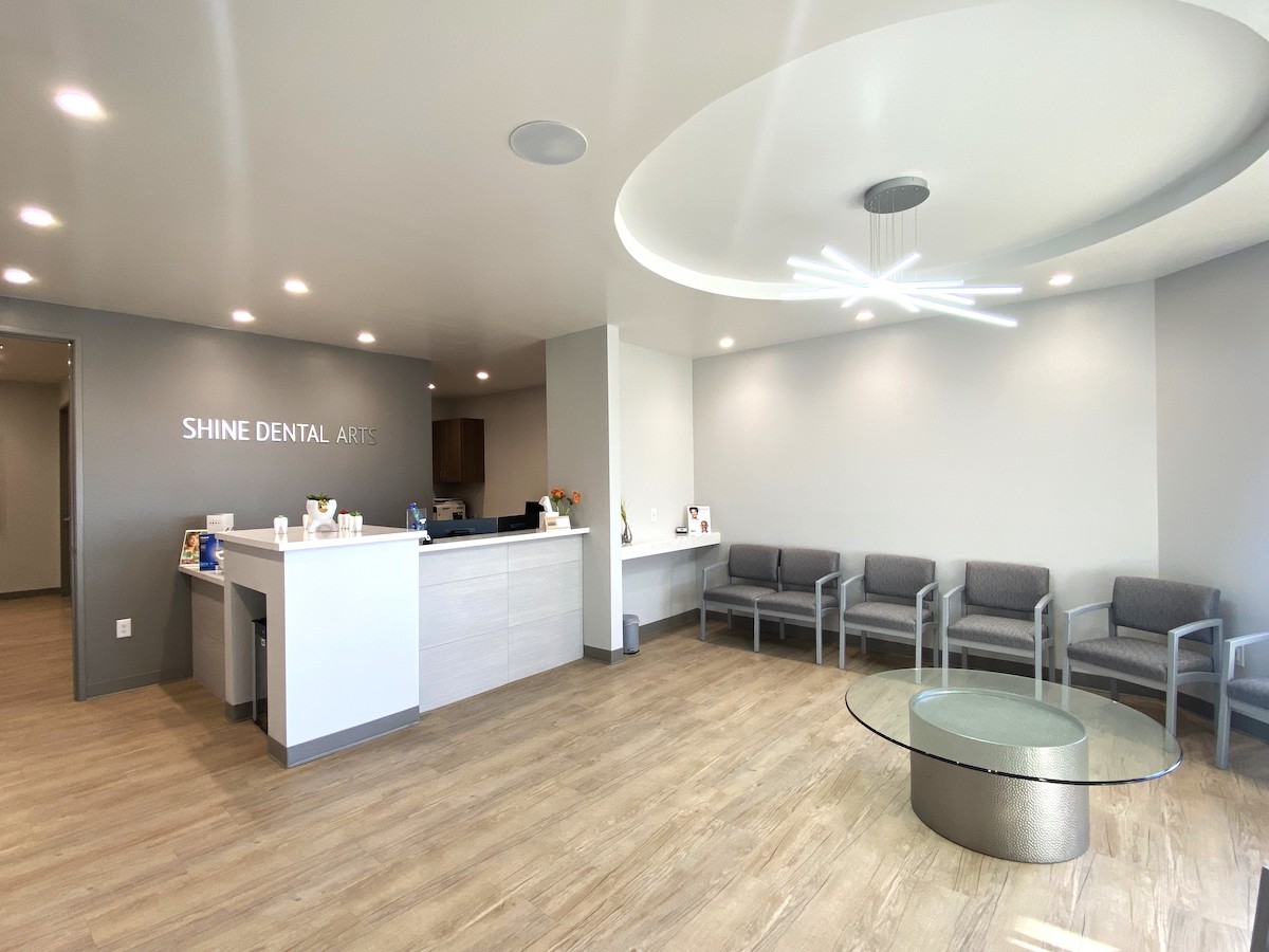 Dental office lobby with desk and sign that reads Shine Dental Arts