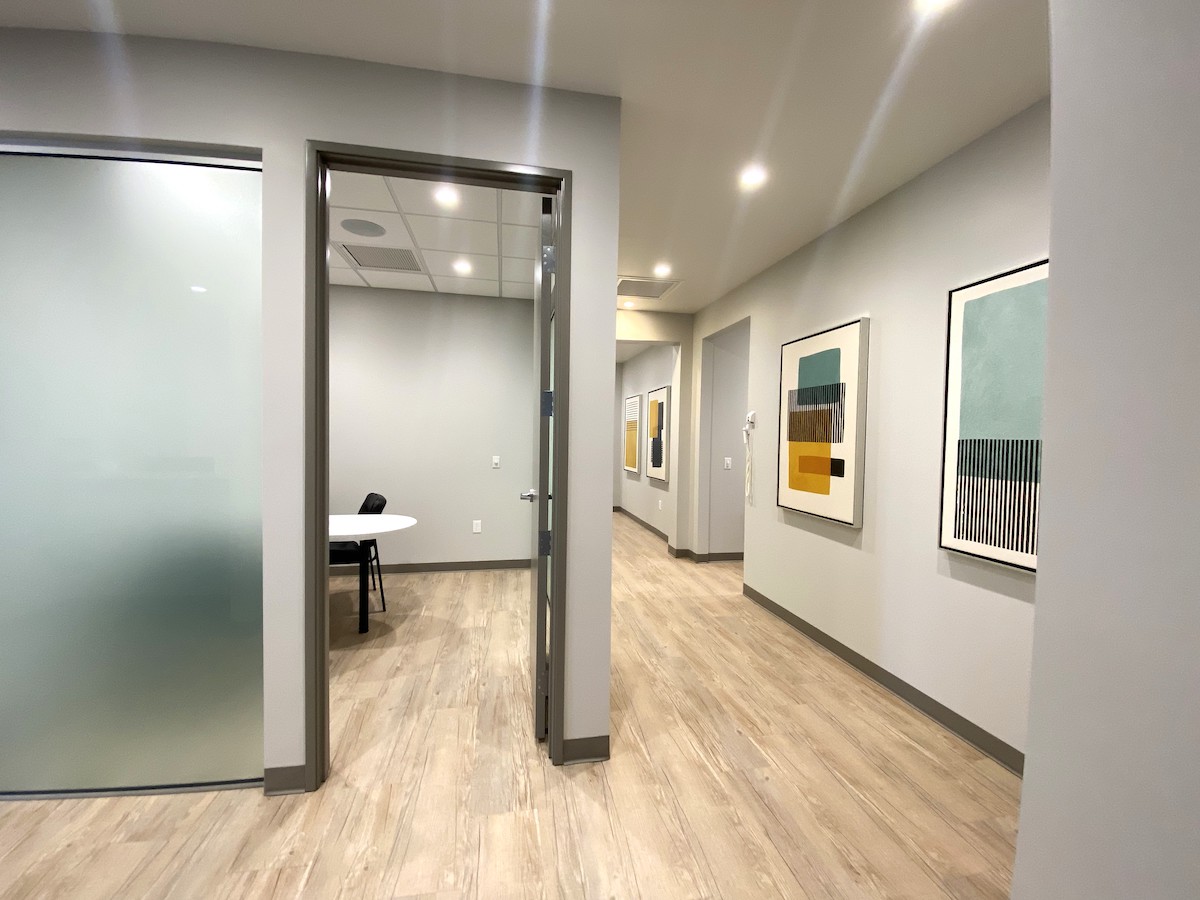 Conference room exterior with frosted glass and abstract paintings on the walls