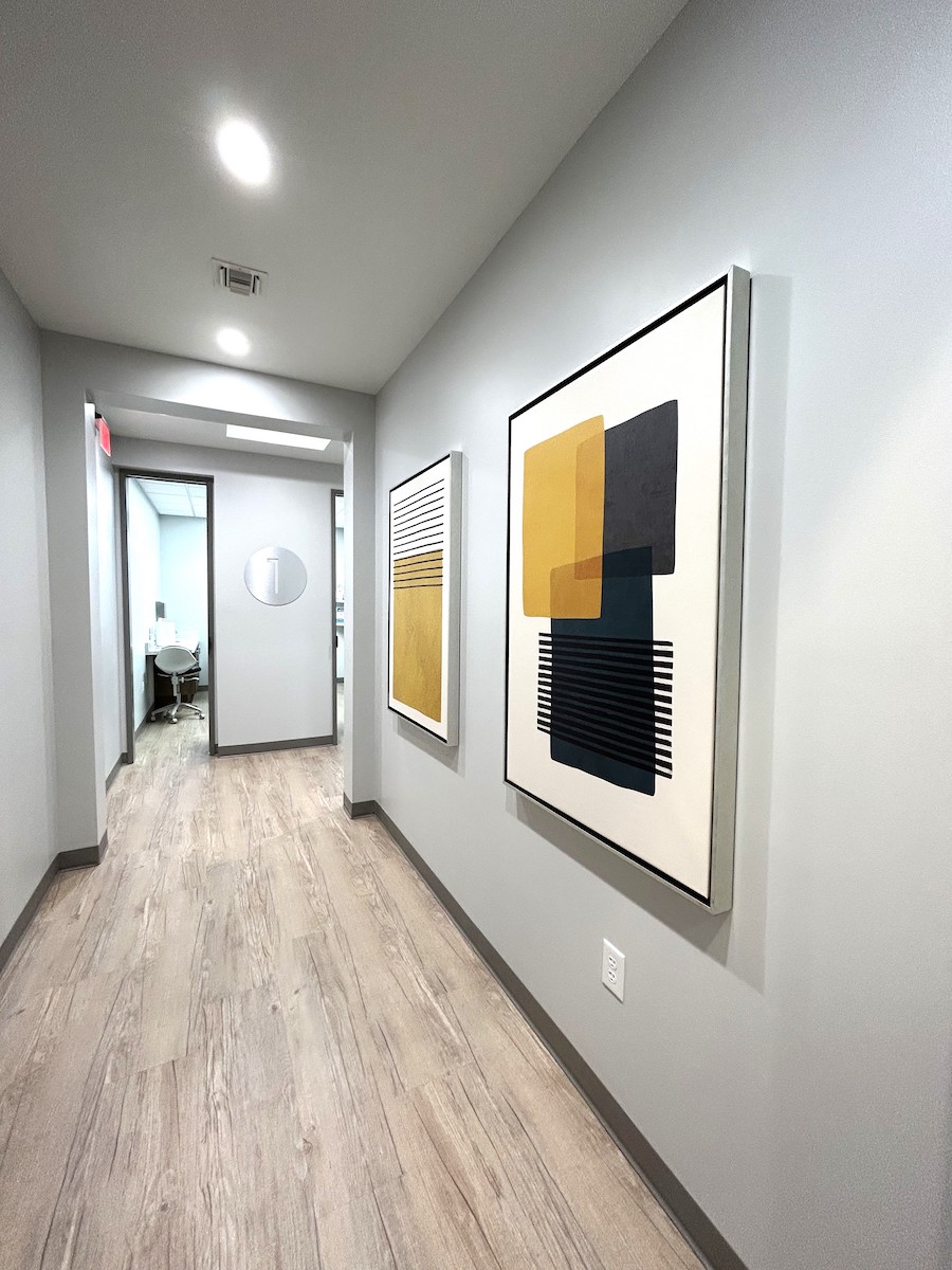 Dental office hallway with yellow and black abstract artwork