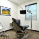 Dental exam chair with window and landscape artwork on the wall