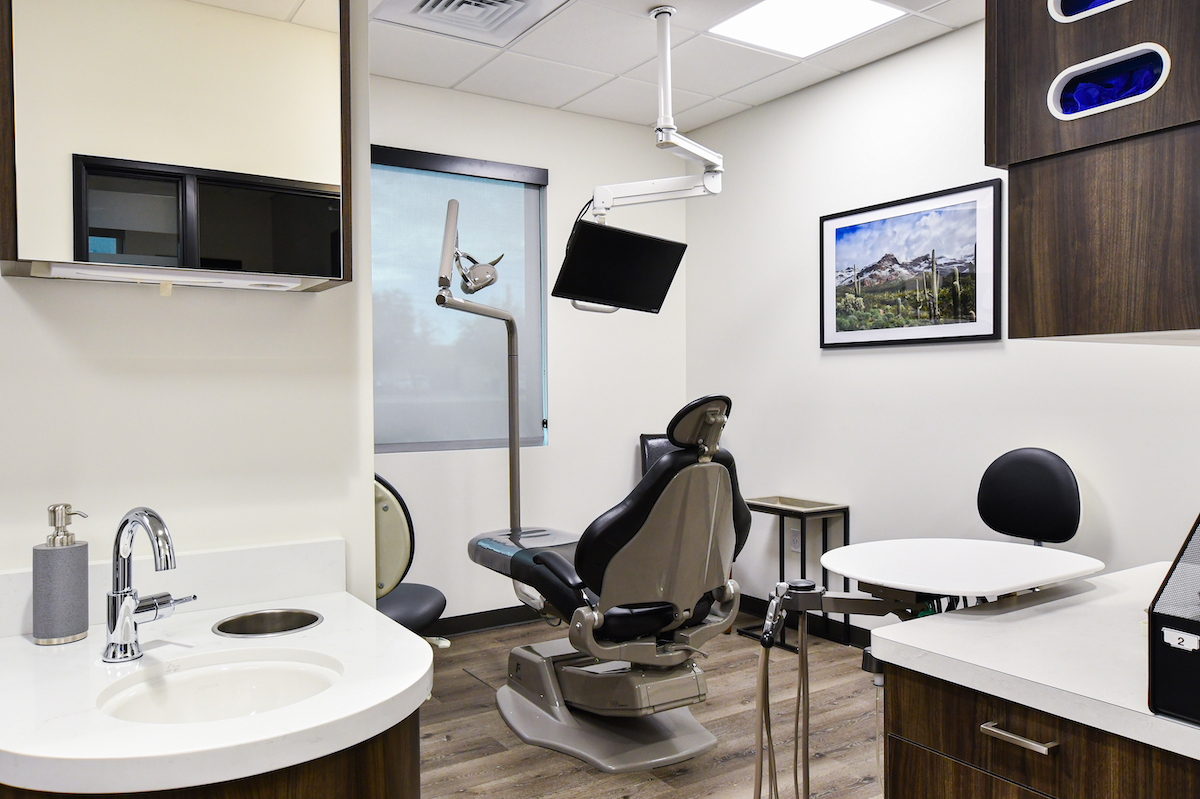 Dental exam room with chair and sink