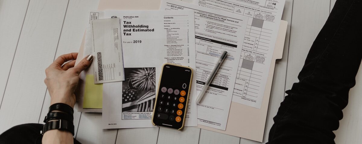 Tax forms and a calculator laid out