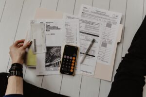 Tax forms and a calculator laid out