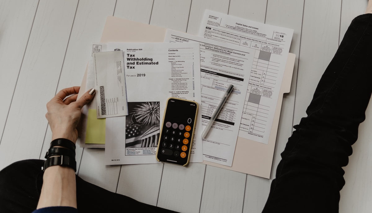 Tax forms and a calculator laid out