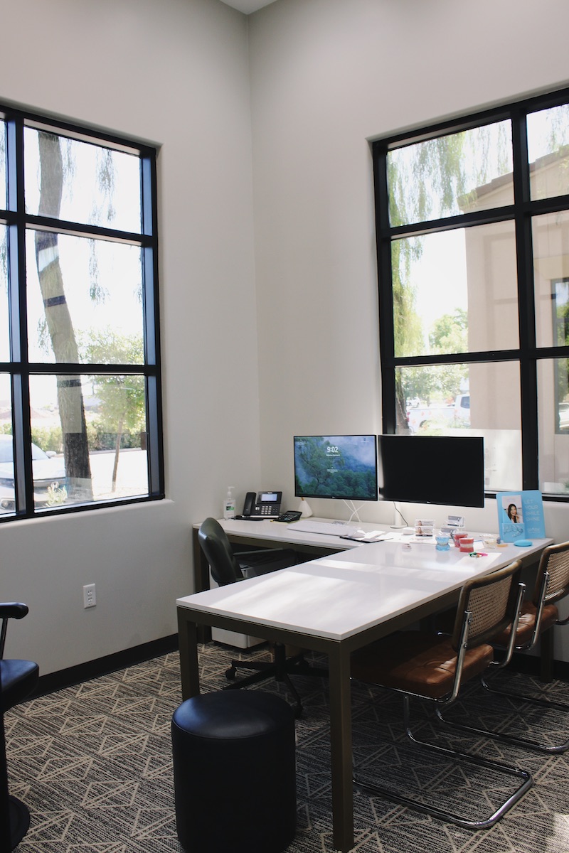 Office with desk, chairs and screens