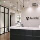 Black desk with writing on the wall that reads Avelle Orthodontics