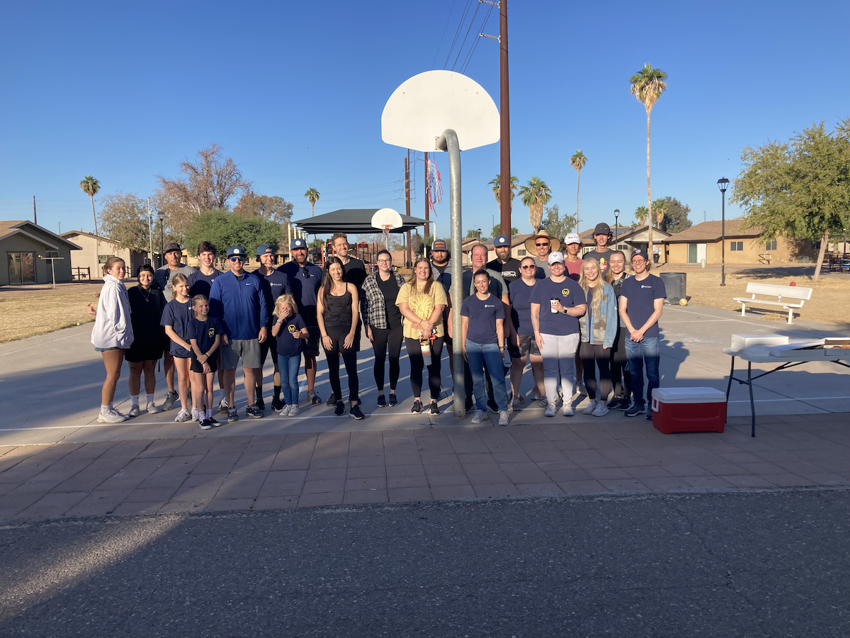 Group of volunteers standing in front of basketball court